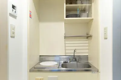 a small kitchen with a sink and a counter at Sakura Yoyogi by Tranova by Tranova in Tokyo
