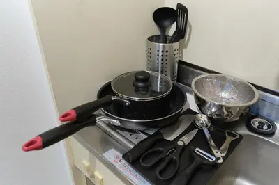 a kitchen stove with a pot and a pan on it at Sakura Yoyogi by Tranova by Tranova in Tokyo