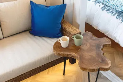 a table with two cups on a bench next to a bed at LAGOON Suite OHANA in Tokyo