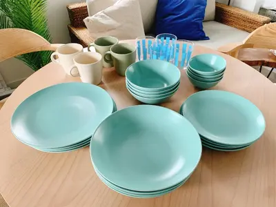 a table with blue plates and cups on it at LAGOON Suite OHANA in Tokyo
