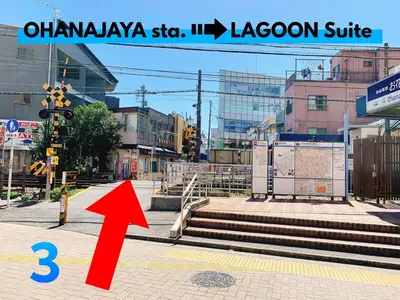 a red arrow is pointing at an empty city street at LAGOON Suite OHANA in Tokyo