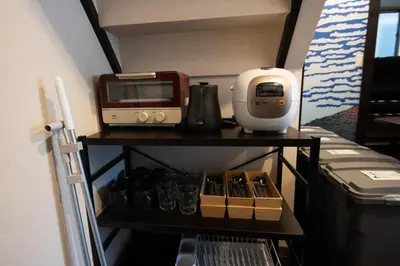 a kitchen shelf with a coffee maker and a toaster at Omori Tei\u5927\u68ee\u4eadOMT 18min to Haneda, 3min Omori, Max 7 people in Tokyo