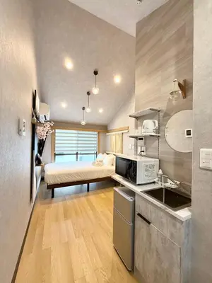 a kitchen with a sink and a bed in a room at fukuhana \u6771\u65b0\u5bbf C3 in Tokyo