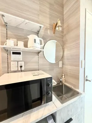 a kitchen with a sink and a microwave at fukuhana \u6771\u65b0\u5bbf C3 in Tokyo