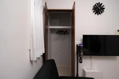 a bathroom with a shower with a television and a shower at Park side stay Shinjuku in Tokyo