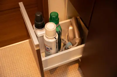 a cupboard with some cleaning products in a bathroom at Park side stay Shinjuku in Tokyo