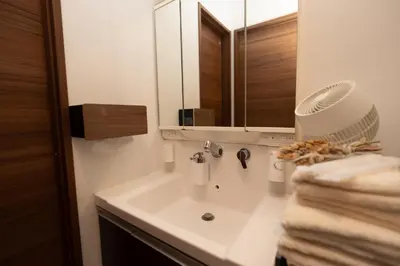 a bathroom with a white sink and a mirror at Park side stay Shinjuku in Tokyo