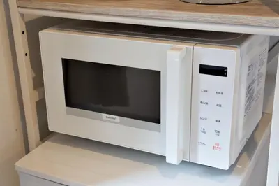 a microwave oven sitting on top of a shelf at Heureux\u690e\u540d\u753a 303 in Tokyo