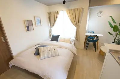a bedroom with a white bed and a window at Heureux\u690e\u540d\u753a 303 in Tokyo