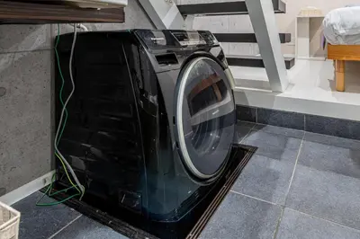 a washing machine sitting on the floor in a room at \u6c60\u888b3\u4e01\u76ee\u6238\u5efa in Tokyo