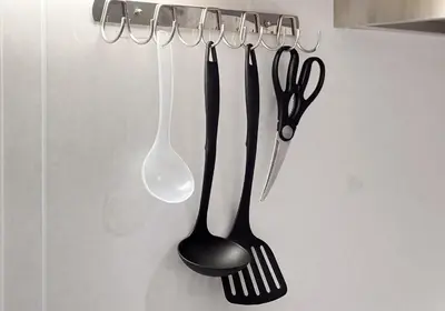 a group of utensils hanging from a rack at \u6c60\u888b3\u4e01\u76ee\u6238\u5efa in Tokyo