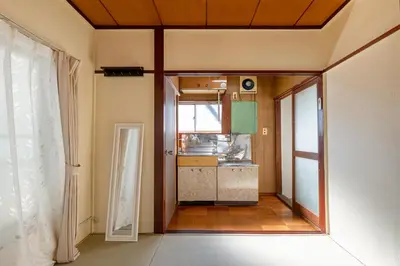 a view of a kitchen from the hallway of a house at \u65e7U\u90b82f3f in Tokyo