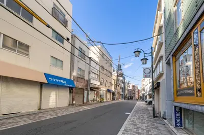 an empty street in a city with buildings at \u65e7U\u90b82f3f in Tokyo