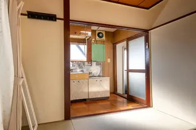 a view of a kitchen from the inside of a room at \u65e7U\u90b82f3f in Tokyo