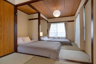 two beds in a room with a window at \u65e7U\u90b82f3f in Tokyo