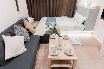 a living room with a couch and a coffee table at Shinjuku SAIEI Hotel 301 in Tokyo