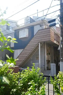 a blue and white house with a porch at D Regalo in Ichikawa