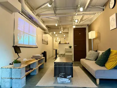 a living room with a couch and a table at The Hotel REPOS SUMIDA1 in Tokyo