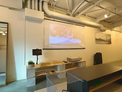 a room with a projection screen on a wall at The Hotel REPOS SUMIDA1 in Tokyo