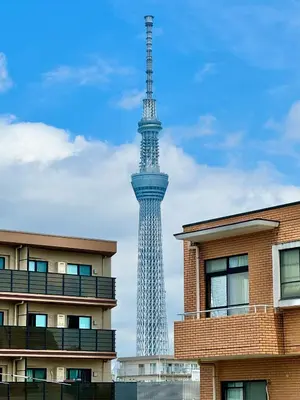 a tv tower in the distance with buildings in the foreground at #601 Tokyo Ryogoku Hokusai Katsushika in Tokyo