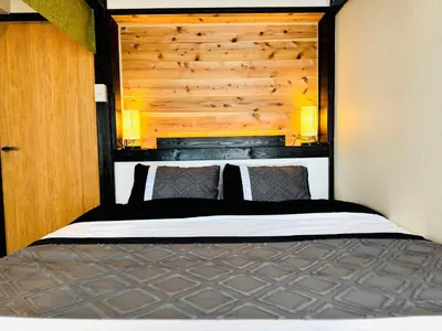 a bedroom with a bed with a wooden headboard at #601 Tokyo Ryogoku Hokusai Katsushika in Tokyo