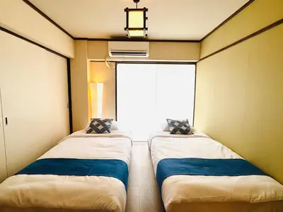 two beds sitting in a room with a window at #601 Tokyo Ryogoku Hokusai Katsushika in Tokyo