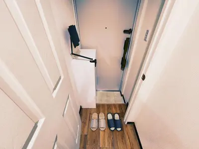 two pairs of shoes sitting on the floor next to a door at The Hotel REPOS SUMIDA2 in Tokyo