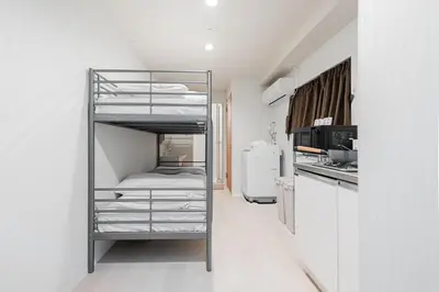 a room with a bunk bed in a kitchen at Shinjuku SAIEI Hotel 202 in Tokyo
