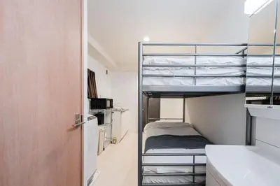 a small room with bunk beds in it at Shinjuku SAIEI Hotel 202 in Tokyo