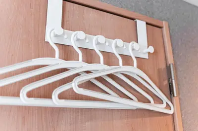 a bunch of white wire hanging from a door at Shinjuku SAIEI Hotel 402 in Tokyo