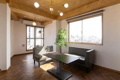 a dining room with a table and chairs and windows at Swan Lake Inn Shinjuku - Vacation STAY 19482 in Tokyo