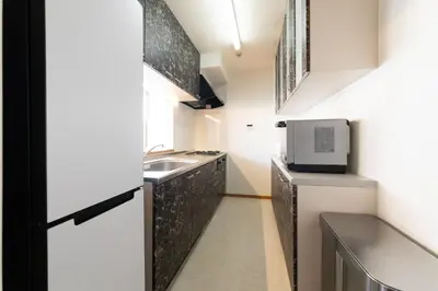 a small kitchen with a sink and a microwave at Swan Lake Inn Shinjuku - Vacation STAY 19482 in Tokyo