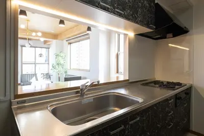 a kitchen with a stainless steel sink and a window at Swan Lake Inn Shinjuku - Vacation STAY 19482 in Tokyo