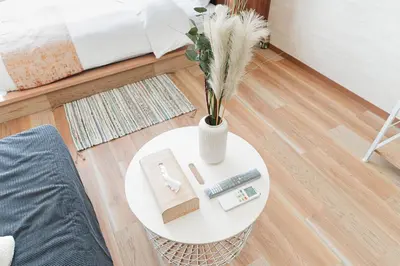 a white table with a vase of flowers on it at Shinjuku SAIEI Hotel 501 in Tokyo