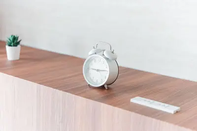 a alarm clock sitting on top of a table at Shinjuku SAIEI Hotel 501 in Tokyo