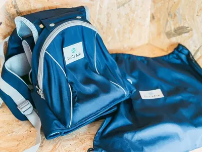 a blue backpack sitting on top of a wooden table at B-C APARTMENT Asakusa Hanazono Dori - Vacation STAY 92836v in Tokyo