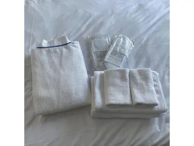 two towels and a bag on a bed at B-C APARTMENT Asakusa Hanazono Dori - Vacation STAY 92849v in Tokyo