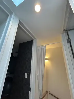 a hallway with a door with a shower curtain at Yoyogi Premier 4BR House in Tokyo