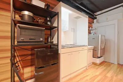 a kitchen with a refrigerator and a microwave at Steps from Shibuya Crossing B in Tokyo
