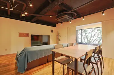 a dining room with a table and a bed at Steps from Shibuya Crossing B in Tokyo