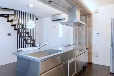 a kitchen with a stainless steel sink and a staircase at \u795e\u5bae\u524d2\u4e01\u76ee in Tokyo
