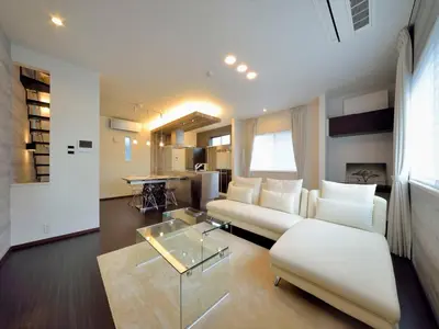 a living room with a white couch and a table at \u795e\u5bae\u524d2\u4e01\u76ee in Tokyo