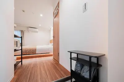 a bedroom with a bed and a table in a room at Shinjuku SAIEI Hotel in Tokyo