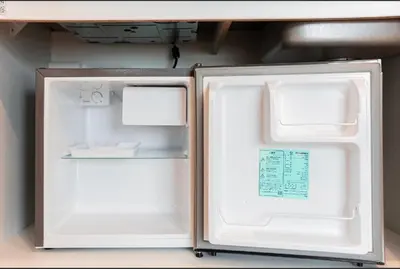 a white refrigerator with its door open in a room at Shinjuku SAIEI Hotel in Tokyo