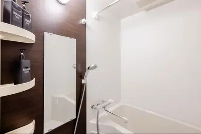 a bathroom with a shower and a sink and a mirror at \u767d\u91d16\u4e01\u76ee401 in Tokyo