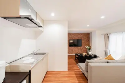 a kitchen and living room with a sink and a couch at Shinjuku SAIEI Horizon Hotel in Tokyo