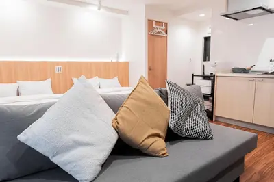 a bedroom with a bed with pillows on it at Shinjuku SAIEI Horizon Hotel in Tokyo