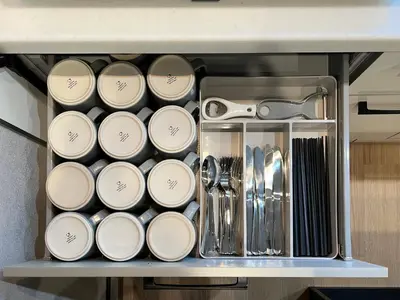 a bunch of dishes and utensils on a shelf at nestay villa tokyo nippori in Tokyo
