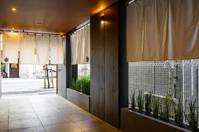 a hallway with curtains and plants in a building at Camo's Tokyo Oshiage in Tokyo