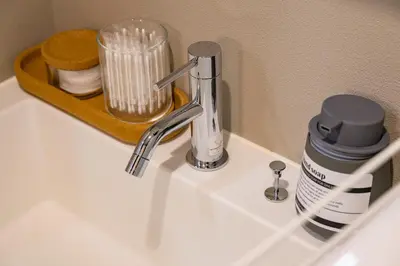 a bathroom sink with a faucet on a counter at Camo's Tokyo Oshiage in Tokyo